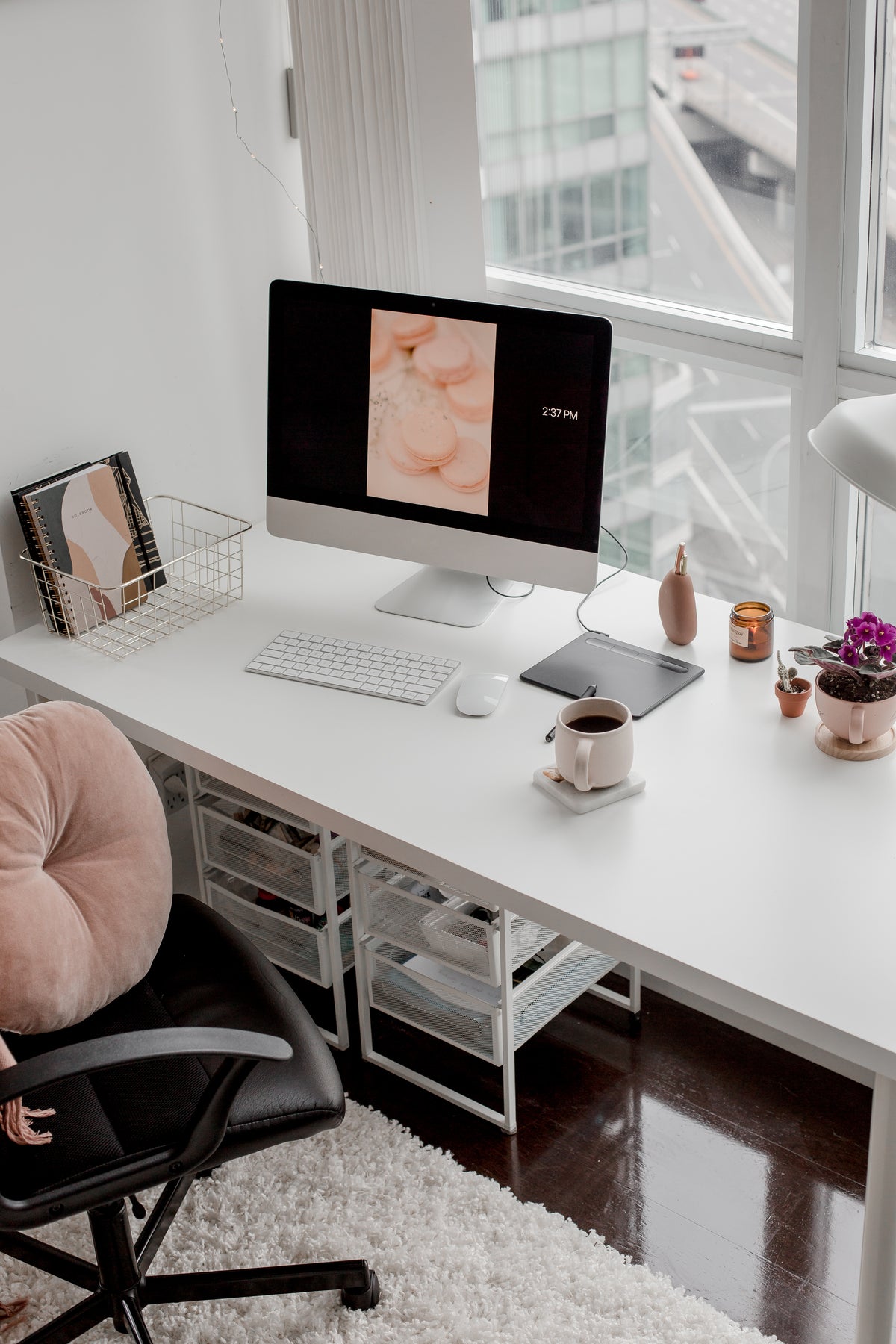 A bright home workspace with a computer, chair, and desk.