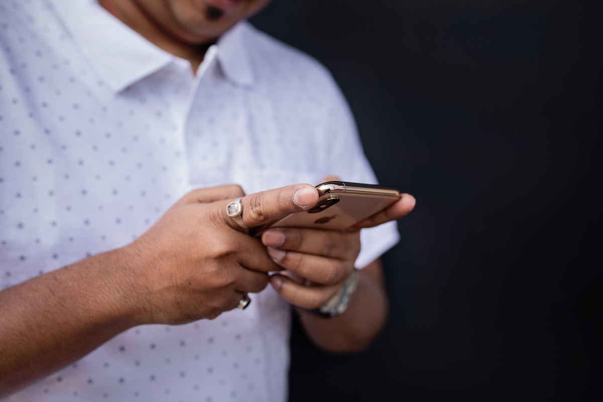 Close view of a person typing on a smartphone.