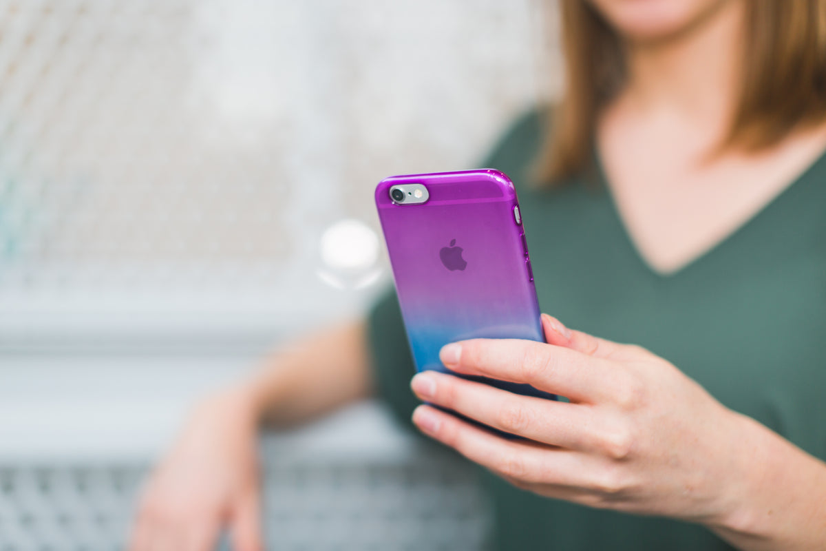 A student holds a smartphone with a colorful case.