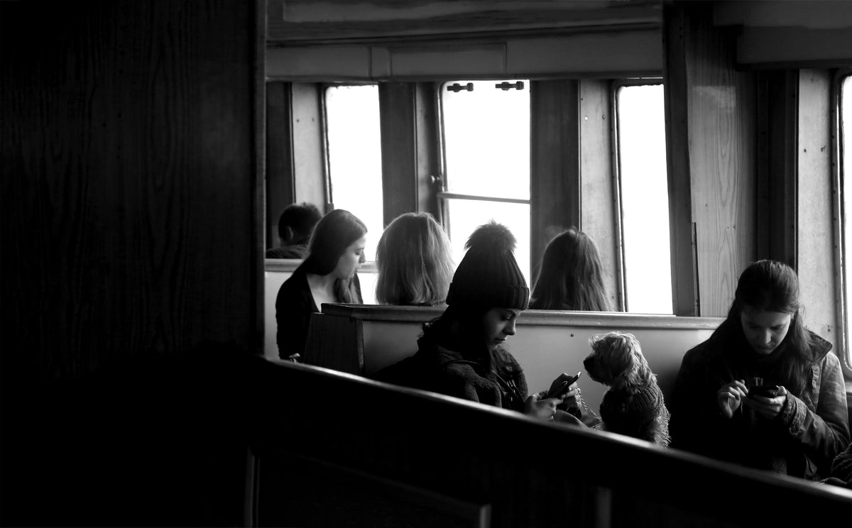 People sit together in conversation near a window.